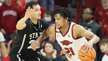 Mar 8, 2025; Fayetteville, Arkansas, USA; Arkansas Razorbacks guard D.J. Wagner (21) drives against Mississippi State Bulldogs forward RJ Melendez (22) during the second half at Bud Walton Arena. Arkansas won 93-92. 