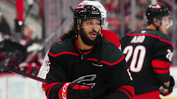 Mar 28, 2025; Raleigh, North Carolina, USA;  Carolina Hurricanes defenseman Jalen Chatfield (5) watches the play against the Montreal Canadiens during the second period at Lenovo Center. Mandatory Credit: James Guillory-Imagn Images