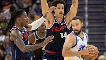 Oct 17, 2025; San Francisco, California, USA; Los Angeles Clippers forward Jahmyl Telfort (19) and center Yanic Konan Niederhäuser (14) double team Golden State Warriors guard Stephen Curry (30) during the fourth quarter at Chase Center. Mandatory Credit: D. Ross Cameron-Imagn Images