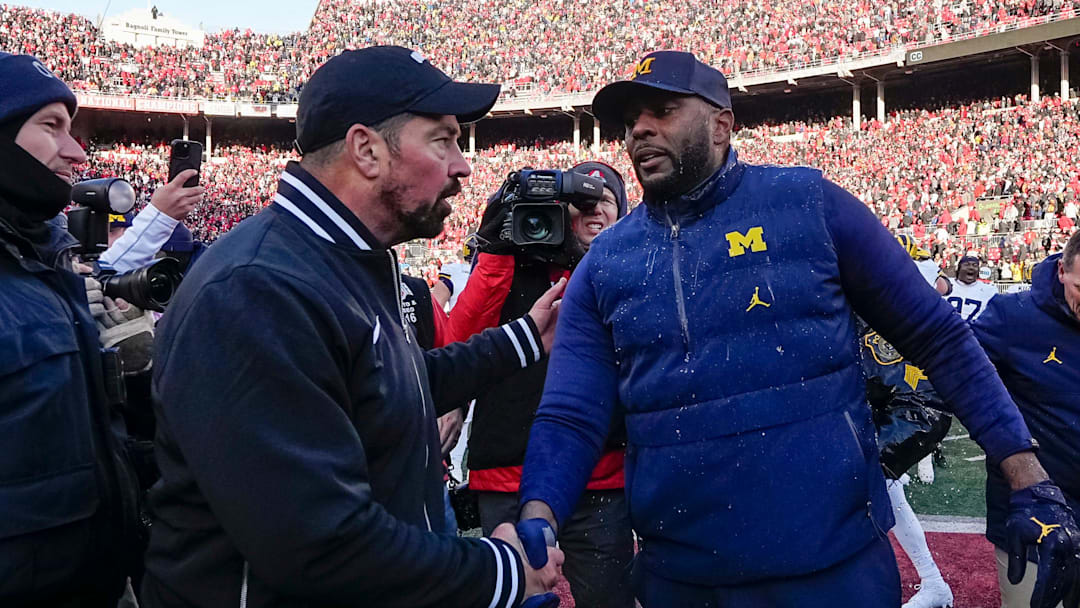 Ohio State Buckeyes head coach Ryan Day shakes hands with Michigan Wolverines head coach Sherrone Moore following the NCAA football game at Ohio Stadium in Columbus on Saturday, Nov. 30, 2024. Michigan won 13-10.