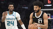 Dec 7, 2025; Charlotte, North Carolina, USA; Denver Nuggets guard Jamal Murray (27) drives in past Charlotte Hornets guard Brandon Miller (24) during the second half at the Spectrum Center.