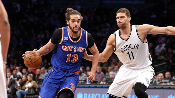 Feb 1, 2017; Brooklyn, NY, USA; New York Knicks center Joakim Noah (13) drives against Brooklyn Nets center Brook Lopez (11) during the first quarter at Barclays Center. Mandatory Credit: Brad Penner-Imagn Images