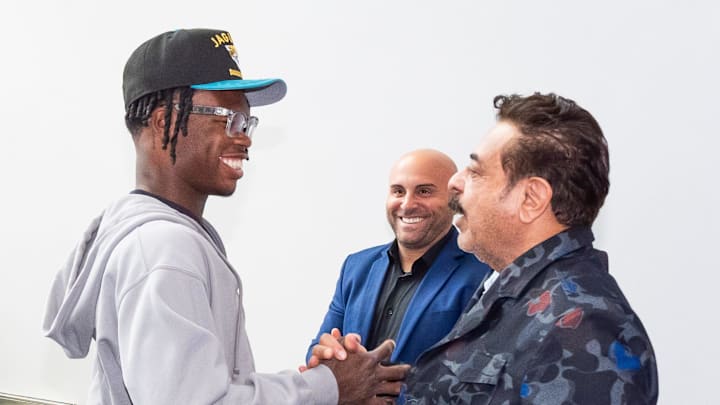 The Jacksonville Jaguars first-round pick, Colorado Buffaloes wide receiver and defensive back Travis Hunter, left, was greeted by Jaguars owner Shahid Khan after Hunter arrived on Friday, March 25, 2025 at Miller Electric Center in Jacksonville, Fla. The team traded up from fifth to second after making a deal with the Cleveland Browns on Thursday night. [Doug Engle/Florida Times-Union]