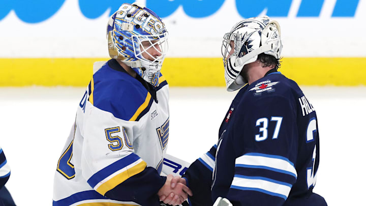 May 4, 2025; Winnipeg, Manitoba, CAN; St. Louis Blues goaltender Jordan Binnington (50) and Winnipeg Jets goaltender Connor Hellebuyck (37) shake hands after the Winnipeg Jets won in double overtime of game seven of the first round of the 2025 Stanley Cup Playoffs at Canada Life Centre. Mandatory Credit: James Carey Lauder-Imagn Images