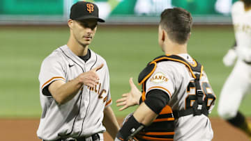 May 13, 2021; Pittsburgh, Pennsylvania, USA; San Francisco Giants relief pitcher Tyler Rogers (L) and catcher Buster Posey (28) shake hands after defeating the Pittsburgh Pirates at PNC Park. Mandatory Credit: Charles LeClaire-Imagn Images