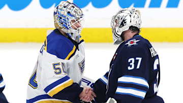 May 4, 2025; Winnipeg, Manitoba, CAN; St. Louis Blues goaltender Jordan Binnington (50) and Winnipeg Jets goaltender Connor Hellebuyck (37) shake hands after the Winnipeg Jets won in double overtime of game seven of the first round of the 2025 Stanley Cup Playoffs at Canada Life Centre. Mandatory Credit: James Carey Lauder-Imagn Images