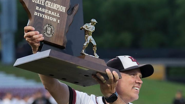 De Pere High School head coach Bob Van Rens hoists the state championship trophy after winning the WIAA Division 1 state baseball title on Thursday, June 13, 2024 at Fox Cities Stadium in Grand Chute, Wis. Tork Mason/USA TODAY NETWORK-Wisconsin De Pere High School head coach Bob Van Rens hoists the state championship trophy after winning the WIAA Division 1 state baseball title on Thursday, June 13, 2024 at Fox Cities Stadium in Grand Chute, Wis. Tork Mason/USA TODAY NETWORK-Wisconsin