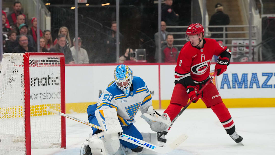 Mar 12, 2026; Raleigh, North Carolina, USA; St. Louis Blues goaltender Jordan Binnington (50) stops the shot in front of Carolina Hurricanes right wing Jackson Blake (53) during the first period at Lenovo Center. Mandatory Credit: James Guillory-Imagn Images Mar 12, 2026; Raleigh, North Carolina, USA; St. Louis Blues goaltender Jordan Binnington (50) stops the shot in front of Carolina Hurricanes right wing Jackson Blake (53) during the first period at Lenovo Center. Mandatory Credit: James Guillory-Imagn Images