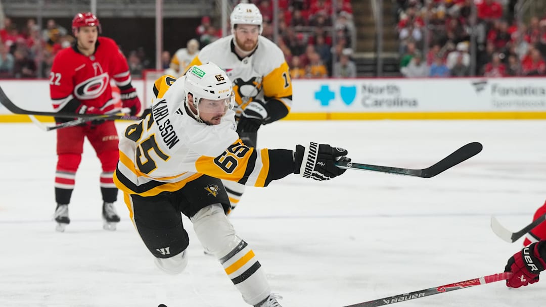 Mar 18, 2026; Raleigh, North Carolina, USA; Pittsburgh Penguins defenseman Erik Karlsson (65) takes a shot against the Carolina Hurricanes during the second period at Lenovo Center. Mandatory Credit: James Guillory-Imagn Images Mar 18, 2026; Raleigh, North Carolina, USA; Pittsburgh Penguins defenseman Erik Karlsson (65) takes a shot against the Carolina Hurricanes during the second period at Lenovo Center. Mandatory Credit: James Guillory-Imagn Images