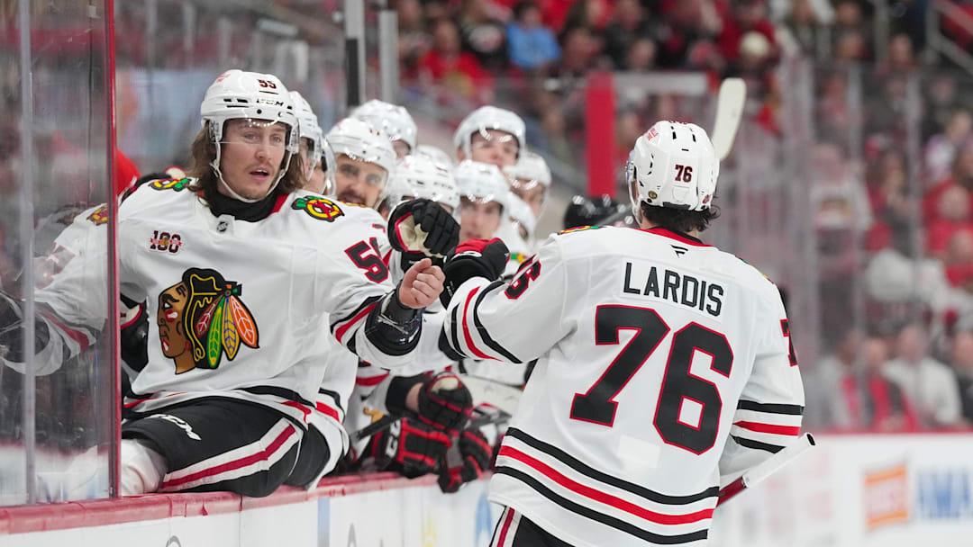Jan 22, 2026; Raleigh, North Carolina, USA;  Chicago Blackhawks left wing Nick Lardis (76) celebrates his goal with left wing Tyler Bertuzzi (59) against the Carolina Hurricanes during the second period at Lenovo Center. Mandatory Credit: James Guillory-Imagn Images