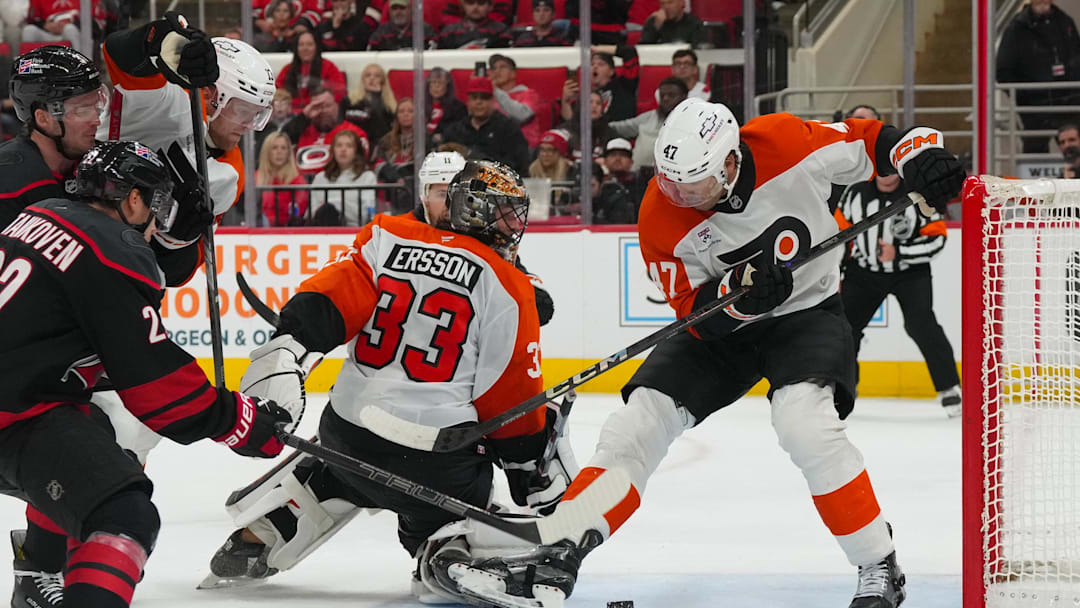 Oct 11, 2025; Raleigh, North Carolina, USA; Philadelphia Flyers defenseman Noah Juulsen (47) and goaltender Samuel Ersson (33) watch the puck in the crease against the Carolina Hurricanes during the third period at Lenovo Center. Mandatory Credit: James Guillory-Imagn Images Oct 11, 2025; Raleigh, North Carolina, USA; Philadelphia Flyers defenseman Noah Juulsen (47) and goaltender Samuel Ersson (33) watch the puck in the crease against the Carolina Hurricanes during the third period at Lenovo Center. Mandatory Credit: James Guillory-Imagn Images