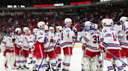 Nov 26, 2025; Raleigh, North Carolina, USA; New York Rangers players celebrate the win against the Carolina Hurricanes at Lenovo Center. Mandatory Credit: James Guillory-Imagn Images