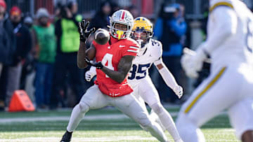 Ohio State wide receiver Jeremiah Smith (4) makes a catch against Michigan defensive back Jyaire Hill (35) during the first half at Ohio Stadium in Columbus, Ohio on Saturday, Nov. 30, 2024.