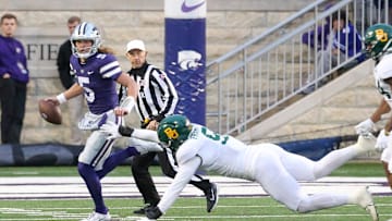 Nov 11, 2023; Manhattan, Kansas, USA; Kansas State Wildcats quarterback Avery Johnson runs away from Baylor Bears defensive lineman TJ Franklin (9) during the fourth quarter at Bill Snyder Family Football Stadium. Mandatory Credit: Scott Sewell-Imagn Images