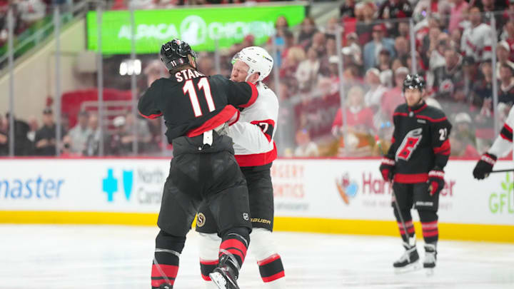 Apr 18, 2026; Raleigh, North Carolina, USA; Ottawa Senators left wing Brady Tkachuk (7) and Carolina Hurricanes center Jordan Staal (11) fight during the first period in game one of the first round of the 2026 Stanley Cup Playoffs at Lenovo Center. Mandatory Credit: James Guillory-Imagn Images