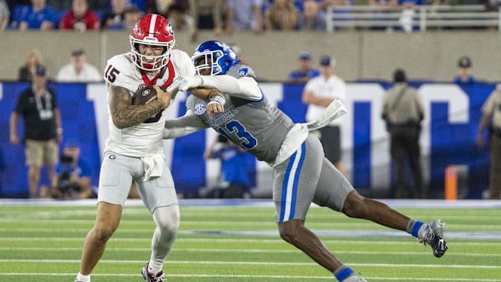 Sep 14, 2024; Lexington, Kentucky, USA; Kentucky Wildcats linebacker J.J. Weaver (13) attempts to sack Georgia Bulldogs quarterback Carson Beck (15) during the fourth quarter at Kroger Field. Mandatory Credit: Tanner Pearson-Imagn Images