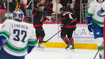 Nov 14, 2025; Raleigh, North Carolina, USA;  Carolina Hurricanes left wing Taylor Hall (71) celebrates his goal with  defenseman Shayne Gostisbehere (4) against the Vancouver Canucks during the third period at Lenovo Center. Mandatory Credit: James Guillory-Imagn Images