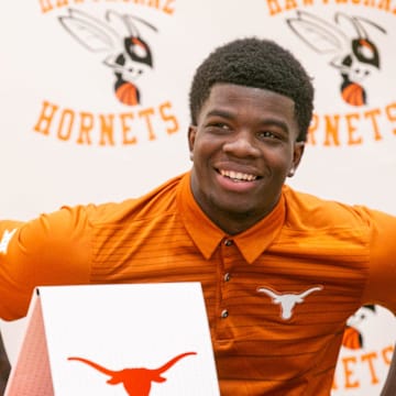 Jerrick Gibson signs his letter of intent to play football at Texas at Hawthorne Middle/High School in Hawthorne, FL on Thursday, December 21, 2023. [Alan Youngblood/Gainesville Sun]