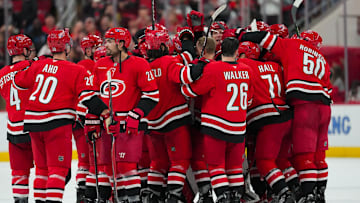 Nov 30, 2025; Raleigh, North Carolina, USA;  Carolina Hurricanes players celebrate their victory against the Calgary Flames in the over time at Lenovo Center. Mandatory Credit: James Guillory-Imagn Images