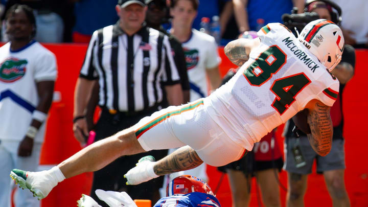 Florida Gators defensive back Jordan Castell (14) upends Miami Hurricanes tight end Cam McCormick (84) as he scores a touchdown during the season opener at Ben Hill Griffin Stadium in Gainesville, FL on Saturday, August 31, 2024 against the University of Miami Hurricanes in the first half. [Doug Engle/Gainesville Sun]