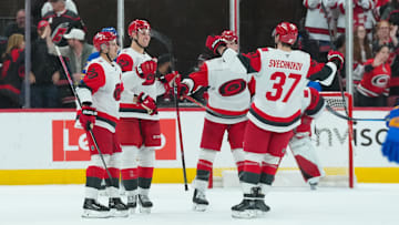 Nov 8, 2025; Raleigh, North Carolina, USA;  Carolina Hurricanes defenseman Charles Alexis Legault (62) celebrates his first NHL goal (empty net) with center Sebastian Aho (20) defenseman Mike Reilly (6) and right wing Andrei Svechnikov (37) against the Buffalo Sabres during the third period at Lenovo Center. Mandatory Credit: James Guillory-Imagn Images