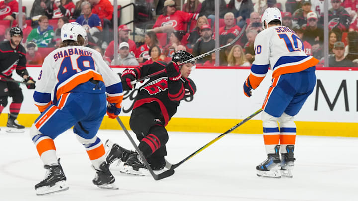 Apr 4, 2026; Raleigh, North Carolina, USA;  Carolina Hurricanes left wing Taylor Hall (71) takes a shot against New York Islanders center Brayden Schenn (10) and right wing Max Shabanov (49) during the third period at Lenovo Center. Mandatory Credit: James Guillory-Imagn Images