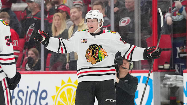 Jan 22, 2026; Raleigh, North Carolina, USA;  Chicago Blackhawks center Oliver Moore (11) scores the game winner in overtime against the Carolina Hurricanes at Lenovo Center. Mandatory Credit: James Guillory-Imagn Images
