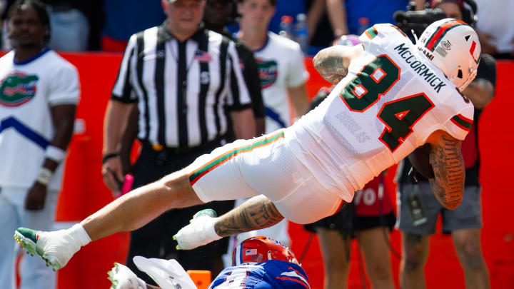 Florida Gators defensive back Jordan Castell (14) upends Miami Hurricanes tight end Cam McCormick (84) as he scores a touchdown during the season opener against the University of Miami Hurricanes. [Doug Engle/Gainesville Sun]