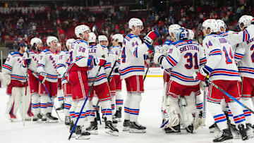 Nov 26, 2025; Raleigh, North Carolina, USA; New York Rangers players celebrate the win against the Carolina Hurricanes at Lenovo Center. Mandatory Credit: James Guillory-Imagn Images