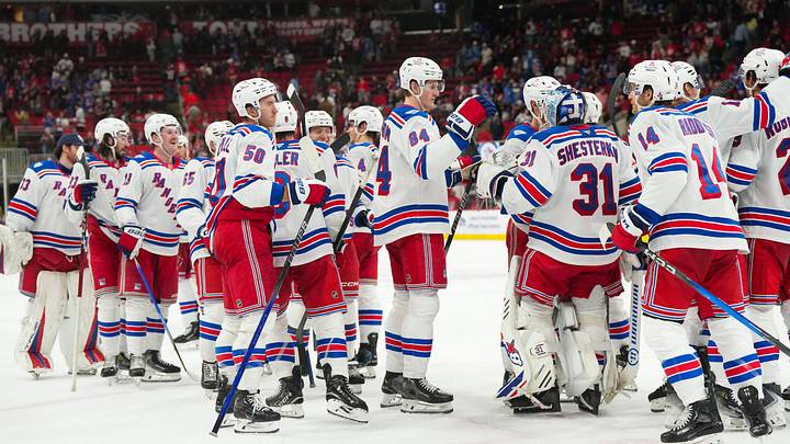Nov 26, 2025; Raleigh, North Carolina, USA; New York Rangers players celebrate the win against the Carolina Hurricanes at Lenovo Center. Mandatory Credit: James Guillory-Imagn Images