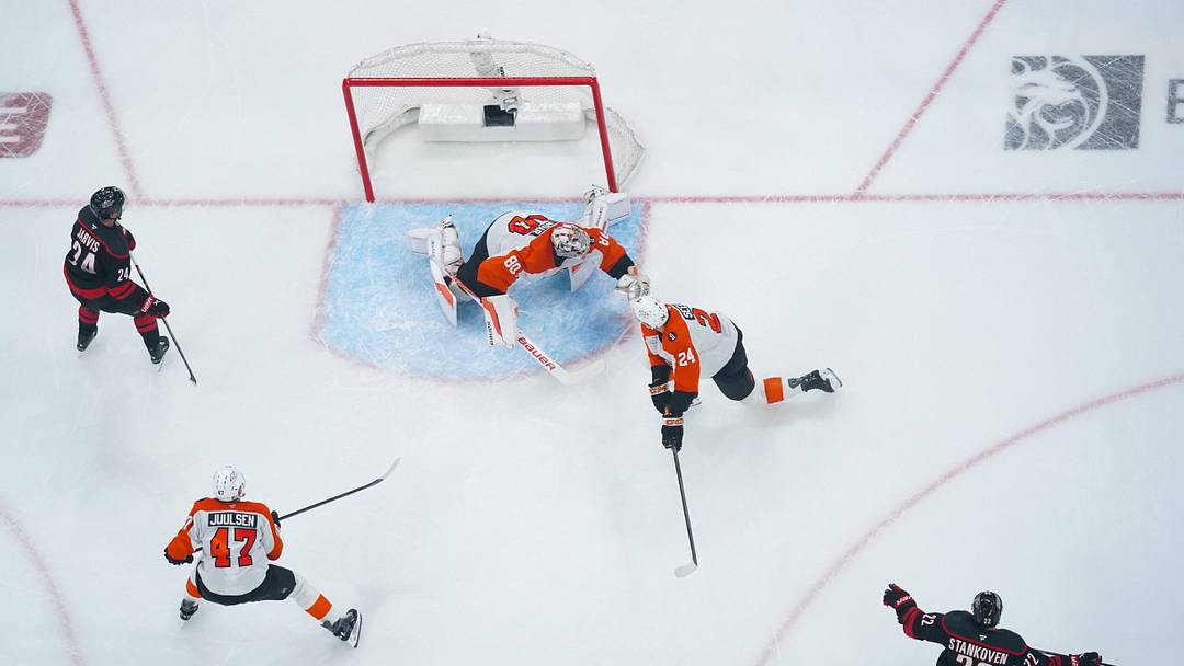 May 2, 2026; Raleigh, North Carolina, USA; Carolina Hurricanes center Logan Stankoven (22) celebrates his goal past Philadelphia Flyers goaltender Dan Vladar (80) and defenseman Nick Seeler (24) during the second period at Lenovo Center. 