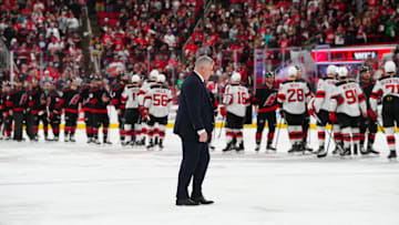 Apr 29, 2025; Raleigh, North Carolina, USA; New Jersey Devils head coach Sheldon Keefe walks to the hand shake line after the loss to the Carolina Hurricanes in the second overtime in game five of the first round of the 2025 Stanley Cup Playoffs at Lenovo Center. Mandatory Credit: James Guillory-Imagn Images