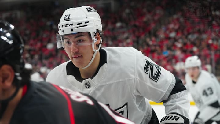 Feb 1, 2025; Raleigh, North Carolina, USA;  Los Angeles Kings defenseman Jordan Spence (21) watches the play against the Carolina Hurricanes during the first period at Lenovo Center. Mandatory Credit: James Guillory-Imagn Images