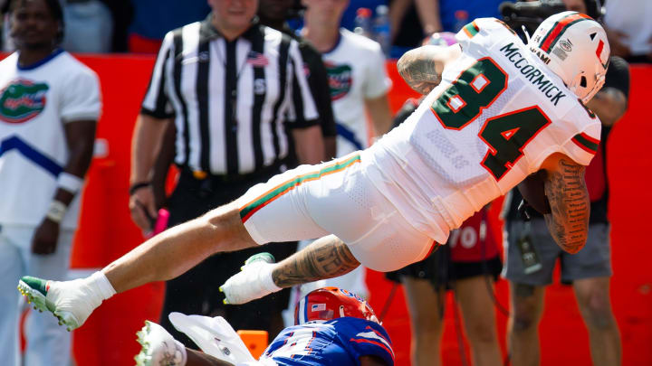 Florida Gators defensive back Jordan Castell (14) upends Miami Hurricanes tight end Cam McCormick (84) as he scores a touchdown during the season opener at Ben Hill Griffin Stadium in Gainesville, FL on Saturday, August 31, 2024 against the University of Miami Hurricanes in the first half. [Doug Engle/Gainesville Sun]