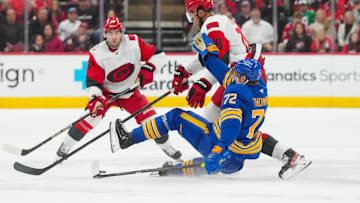 Nov 8, 2025; Raleigh, North Carolina, USA;  Carolina Hurricanes defenseman K'Andre Miller (19) checks Buffalo Sabres center Tage Thompson (72) during the third period at Lenovo Center. Mandatory Credit: James Guillory-Imagn Images