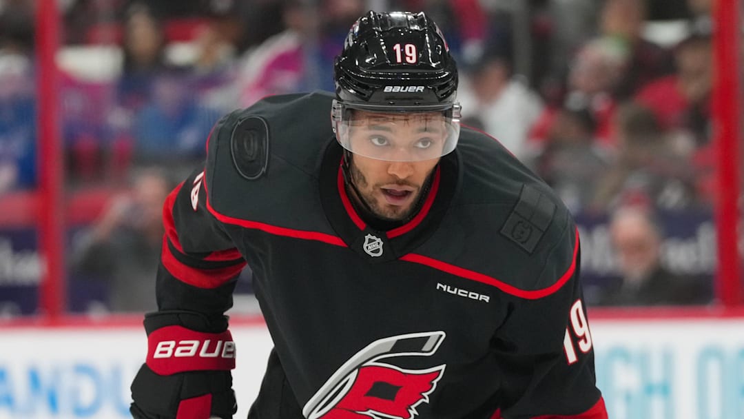 Oct 9, 2025; Raleigh, North Carolina, USA;  Carolina Hurricanes defenseman K'Andre Miller (19) looks on against the New Jersey Devils during the first period at Lenovo Center. Mandatory Credit: James Guillory-Imagn Images