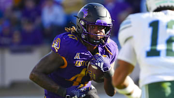 Nov 4, 2023; Greenville, North Carolina, USA;  East Carolina Pirates running back Rahjai Harris (47) runs with the ball against the Tulane Green Wave during the first half at Dowdy-Ficklen Stadium. Mandatory Credit: James Guillory-Imagn Images