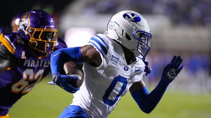 Sep 20, 2025; Greenville, North Carolina, USA;  Brigham Young Cougars cornerback Evan Johnson (0) runs with the ball after his interception against the East Carolina Pirates during the first half at Dowdy-Ficklen Stadium. Mandatory Credit: James Guillory-Imagn Images