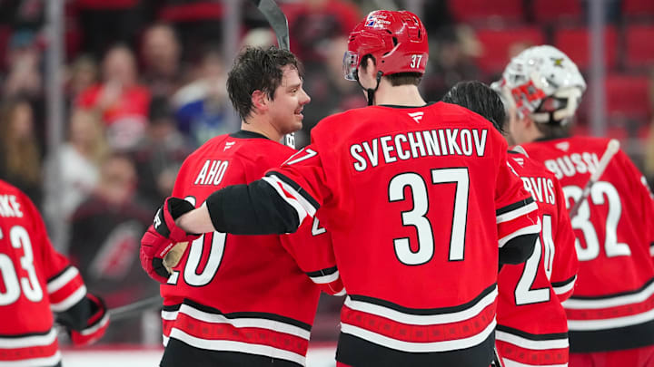 Feb 1, 2026; Raleigh, North Carolina, USA; Carolina Hurricanes center Sebastian Aho (20) and right wing Andrei Svechnikov (37) celebrate their victory against the Los Angeles Kings at Lenovo Center. Mandatory Credit: James Guillory-Imagn Images