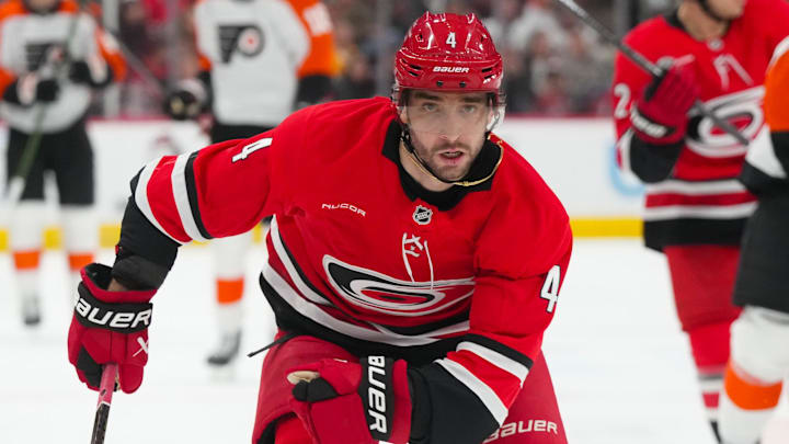 Dec 14, 2025; Raleigh, North Carolina, USA; Carolina Hurricanes defenseman Shayne Gostisbehere (4) skates against the Philadelphia Flyers during the second period at Lenovo Center. Mandatory Credit: James Guillory-Imagn Images