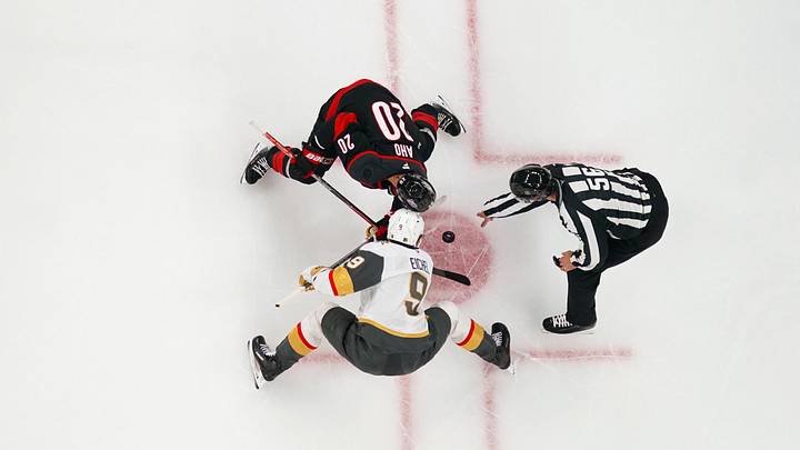 Oct 28, 2025; Raleigh, North Carolina, USA;  Vegas Golden Knights center Jack Eichel (9) and Carolina Hurricanes center Sebastian Aho (20) take a face off during the first period at Lenovo Center. Mandatory Credit: James Guillory-Imagn Images