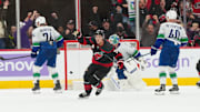 Nov 14, 2025; Raleigh, North Carolina, USA;  Carolina Hurricanes center Sebastian Aho (20) celebrates his game winning over time goal against the Vancouver Canucks at Lenovo Center. Mandatory Credit: James Guillory-Imagn Images