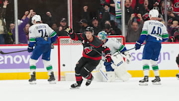 Nov 14, 2025; Raleigh, North Carolina, USA;  Carolina Hurricanes center Sebastian Aho (20) celebrates his game winning over time goal against the Vancouver Canucks at Lenovo Center. Mandatory Credit: James Guillory-Imagn Images