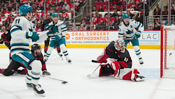 Dec 7, 2025; Raleigh, North Carolina, USA;  San Jose Sharks center Alexander Wennberg (21) scores a goal past Carolina Hurricanes goaltender Pyotr Kochetkov (52) during the second period at Lenovo Center. Mandatory Credit: James Guillory-Imagn Images