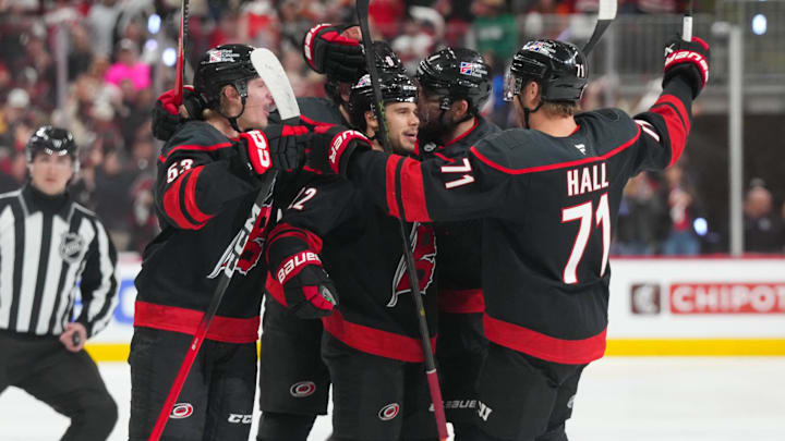 May 2, 2026; Raleigh, North Carolina, USA;  Carolina Hurricanes center Logan Stankoven (22) is congratulated by left wing Taylor Hall (71) and right wing Jackson Blake (53) after his goal against the Philadelphia Flyers during the first period at Lenovo Center. Mandatory Credit: James Guillory-Imagn Images