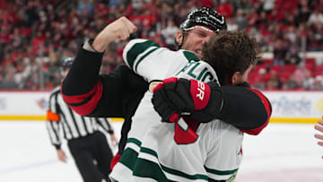 Nov 6, 2025; Raleigh, North Carolina, USA;  Carolina Hurricanes center Jordan Staal (11) fights Minnesota Wild center Tyler Pitlick (19) during the first period at Lenovo Center. Mandatory Credit: James Guillory-Imagn Images