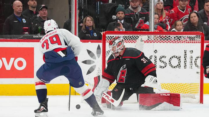 Nov 11, 2025; Raleigh, North Carolina, USA;  Carolina Hurricanes goaltender Frederik Andersen (31) stops the shot attempt by Washington Capitals center Hendrix Lapierre (29) during the first period at Lenovo Center. Mandatory Credit: James Guillory-Imagn Images
