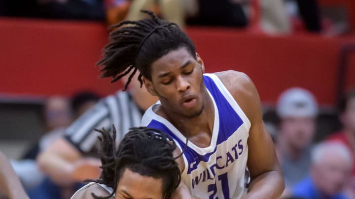 Richwoods' Tavie Smith, left, collides with Harvey Thornton's Morez Johnson Jr. in the second half of their Class 3A boys basketball supersectional Monday, March 4, 2024 at Ottawa High School. The Knights advanced to the state semifinals with a 58-52 win.