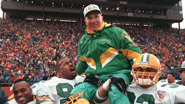 1994     Oregon coach Rich Brooks is carried off the field following the Ducks' 17   13 victory.