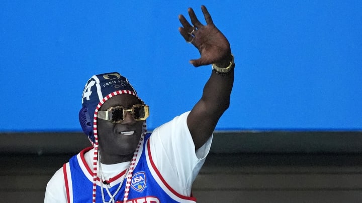 Jul 27, 2024; Paris, France; Recording artist Flavor Flav waves to the crowd during the match between Greece and United States of America in women’s water polo group B play during the Paris 2024 Olympic Summer Games at Aquatics Centre.